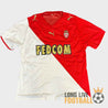 Maillot domicile AS Monaco 2008-2009 par Puma, design rouge et blanc à diagonale, sponsor Fedcom doré sur la poitrine